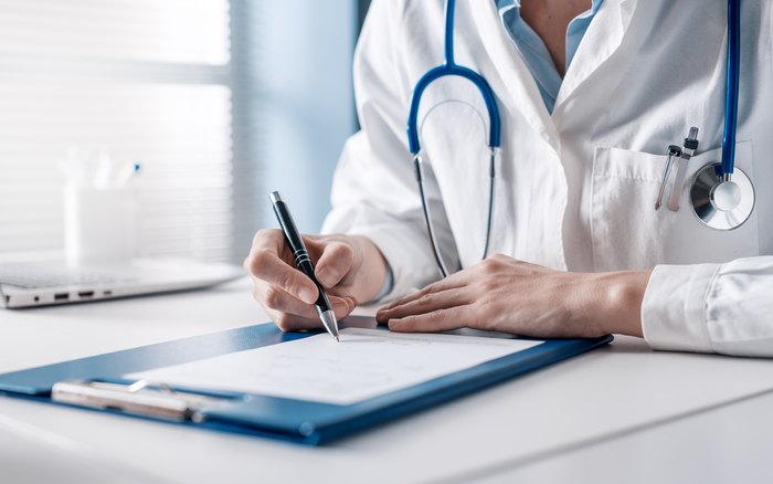 A Physician signing a clinical directive, the kind of prescriber-ready paperwork sold in the shop